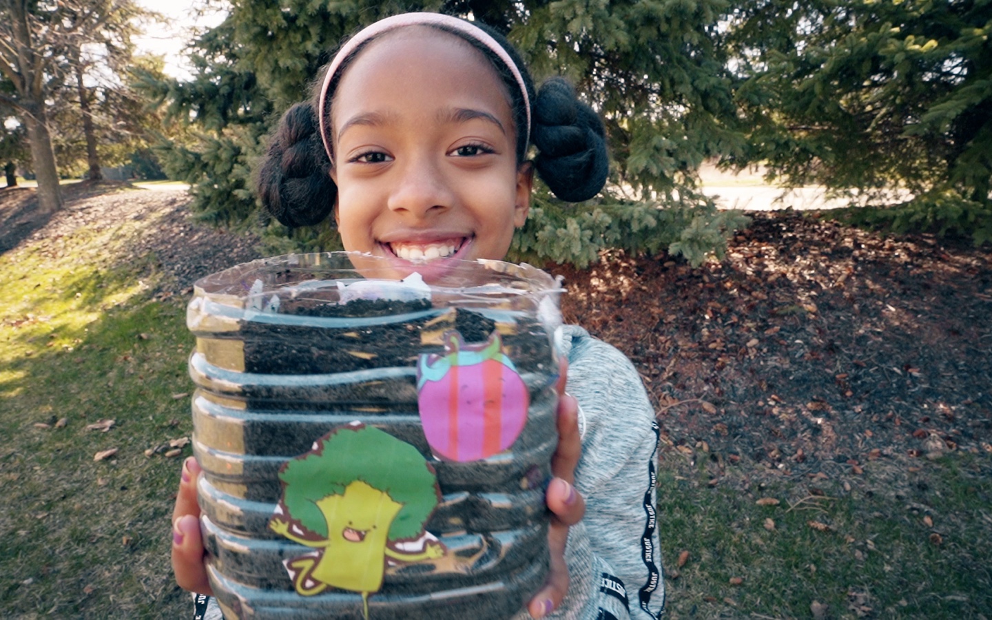 Young Girl Reusing Plastic Bottle As A Planter