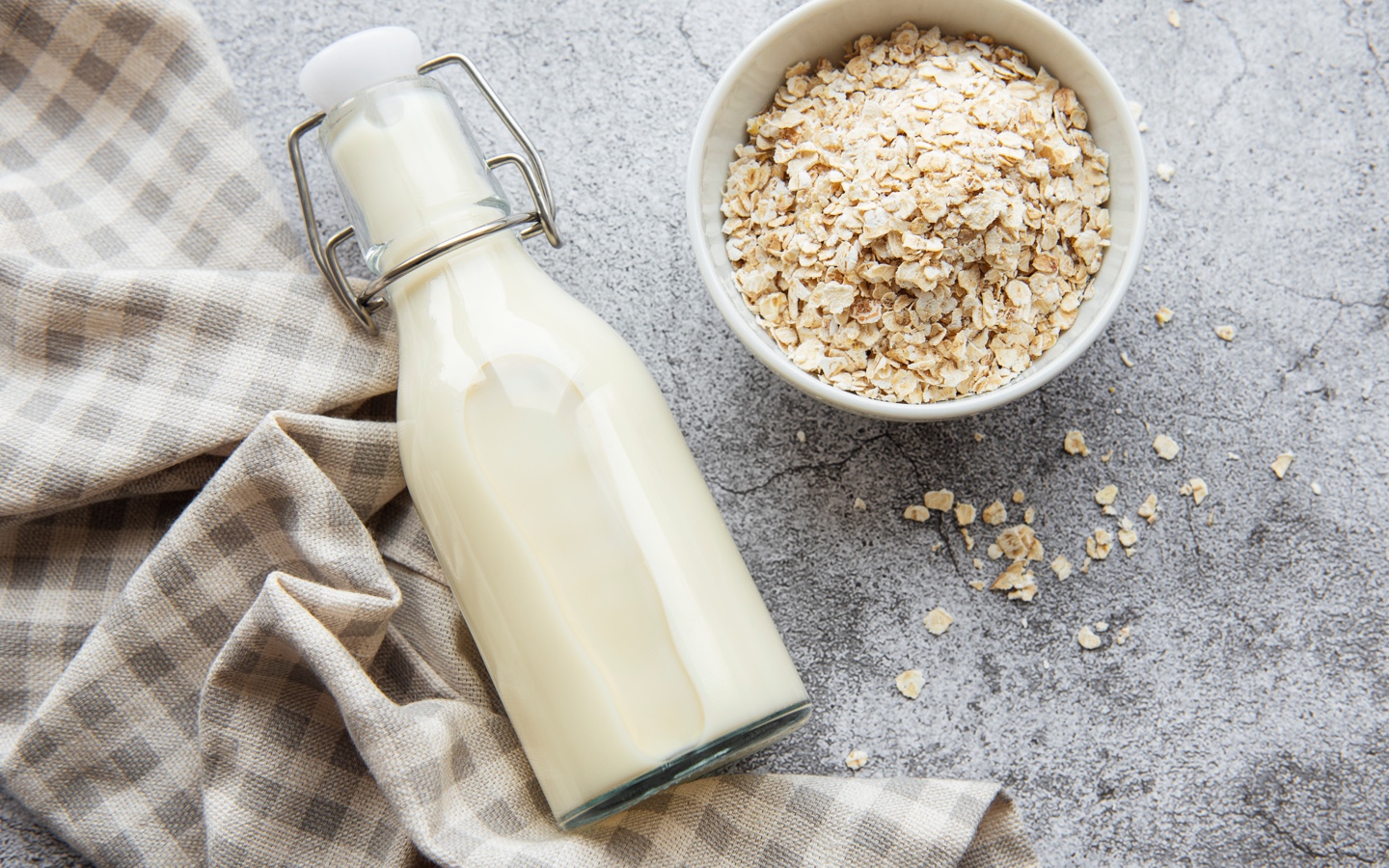 Bowl of Oats and Bottle of Oat Milk