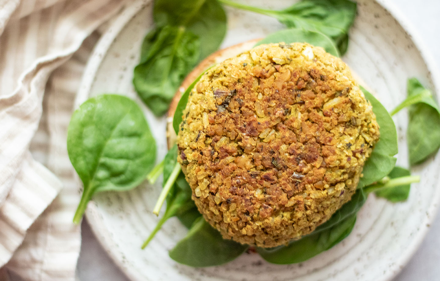 Vegan Curry Chickpea Burger On Plate With Spinach