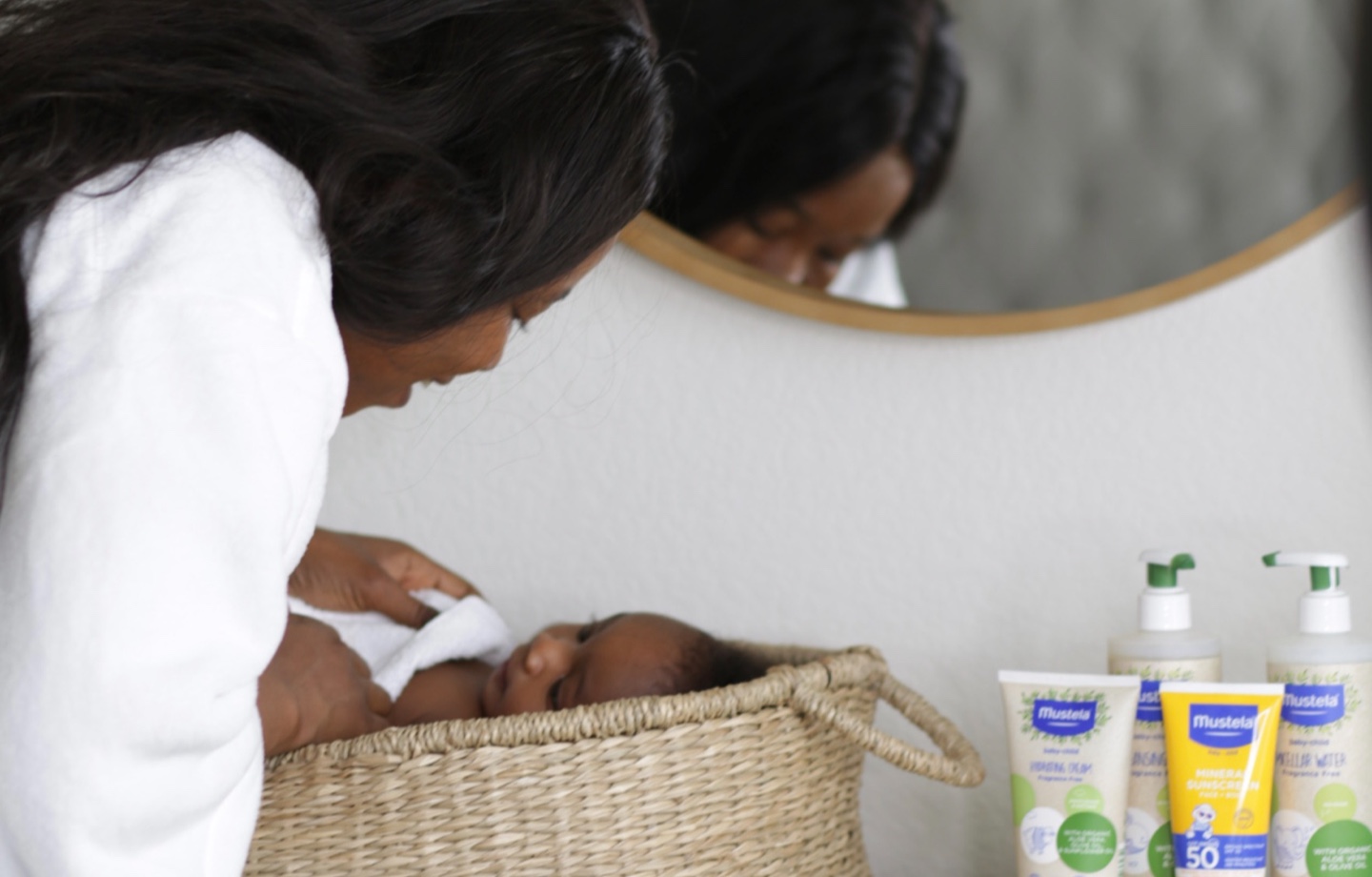 Parent Using Mustela Products on Infant