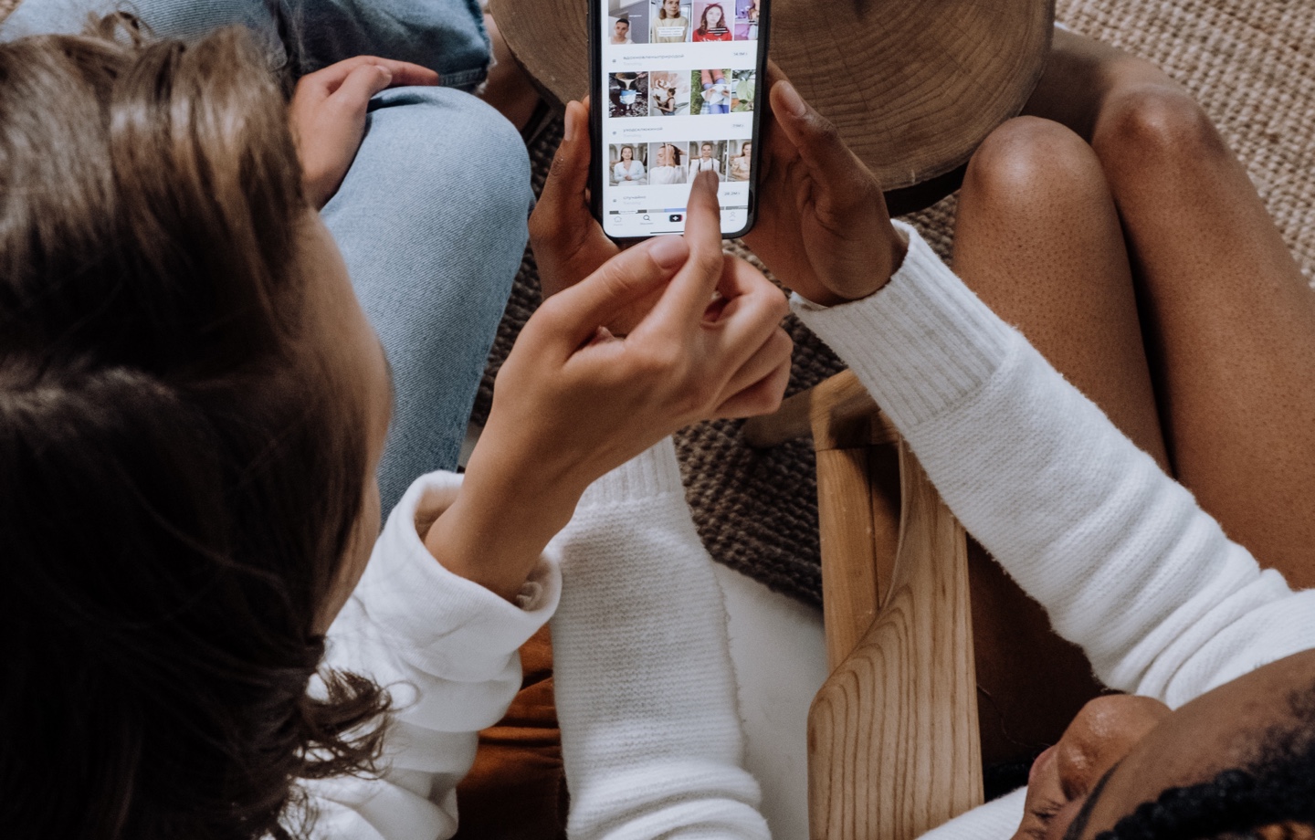 two friends browsing social media app on a phone