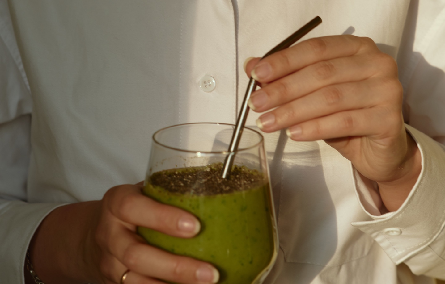 woman holding plant based smoothie