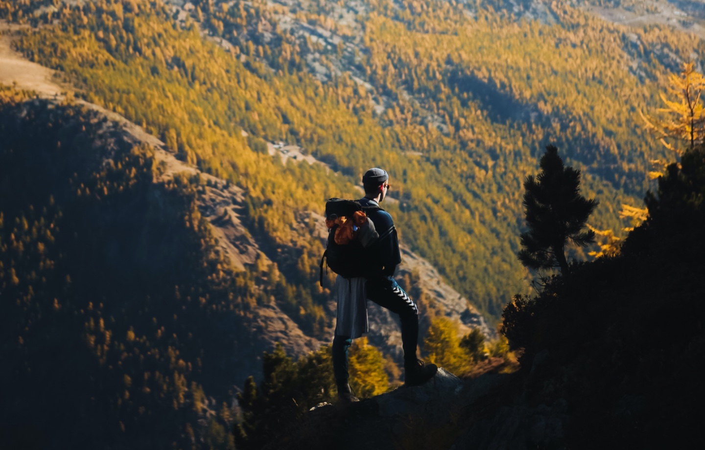 man admiring mountain range during hike