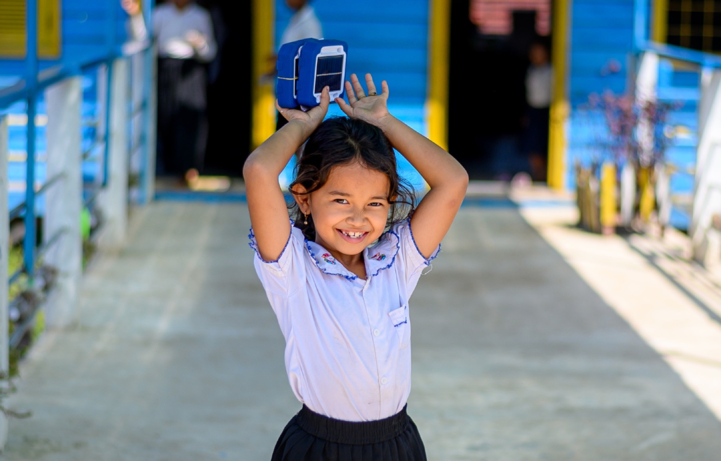 child holding two junior buddy lights