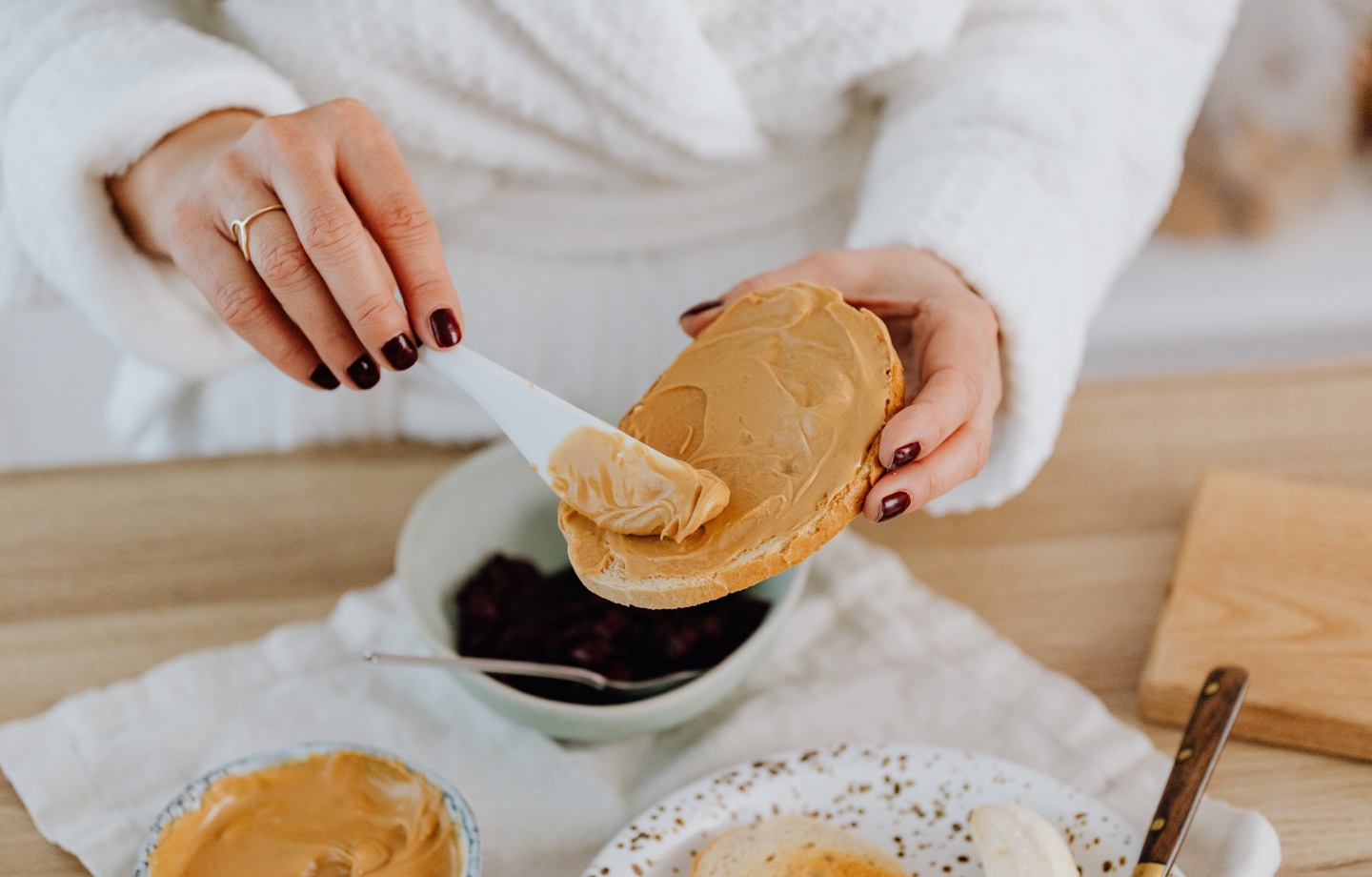 spreading peanut butter on toast