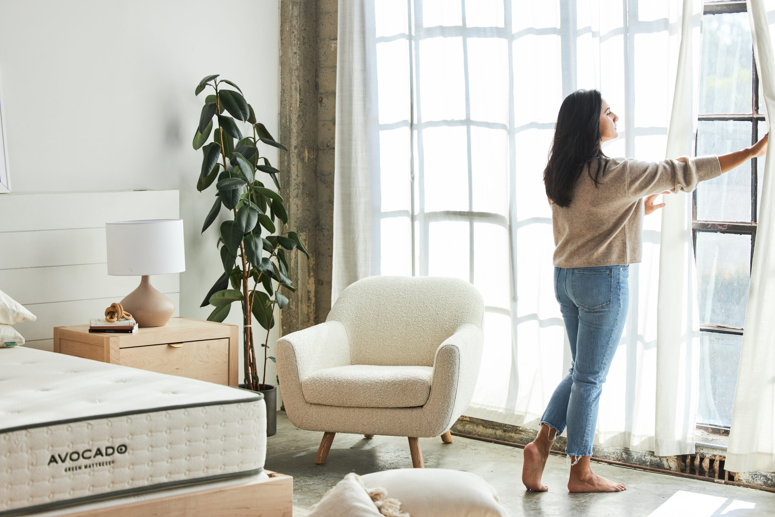woman opening curtains in the morning