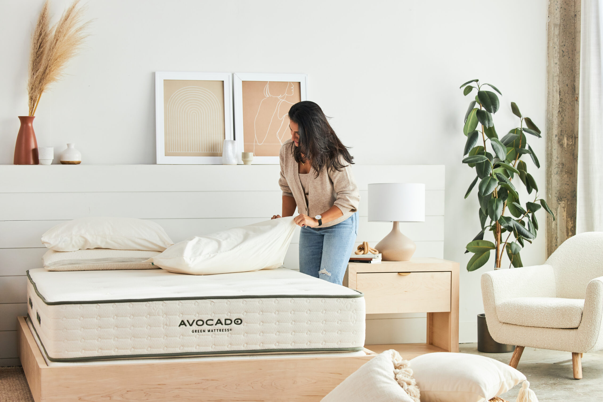 woman putting pillowcases on avocado pillows