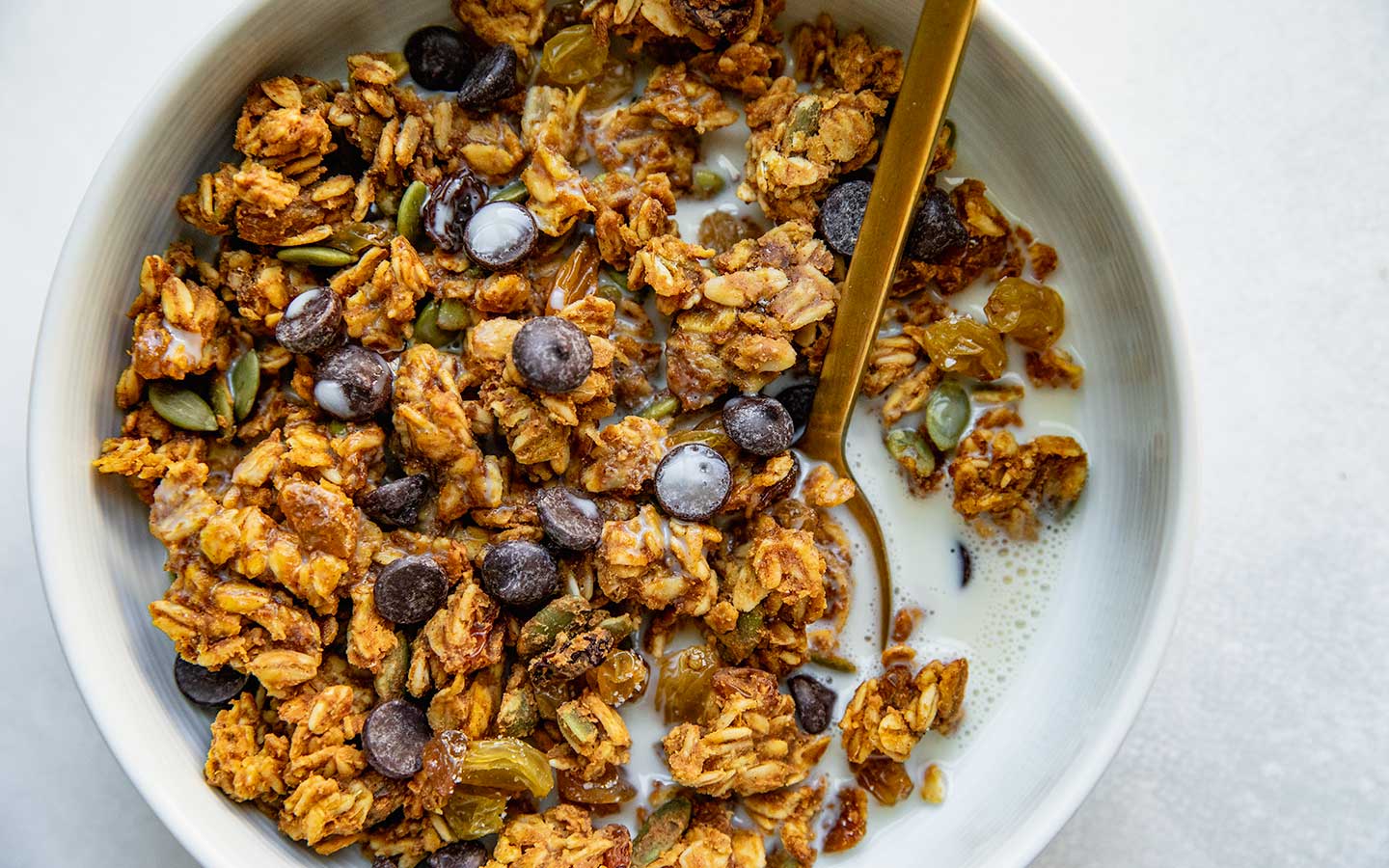pumpkin spice granola in a bowl with milk