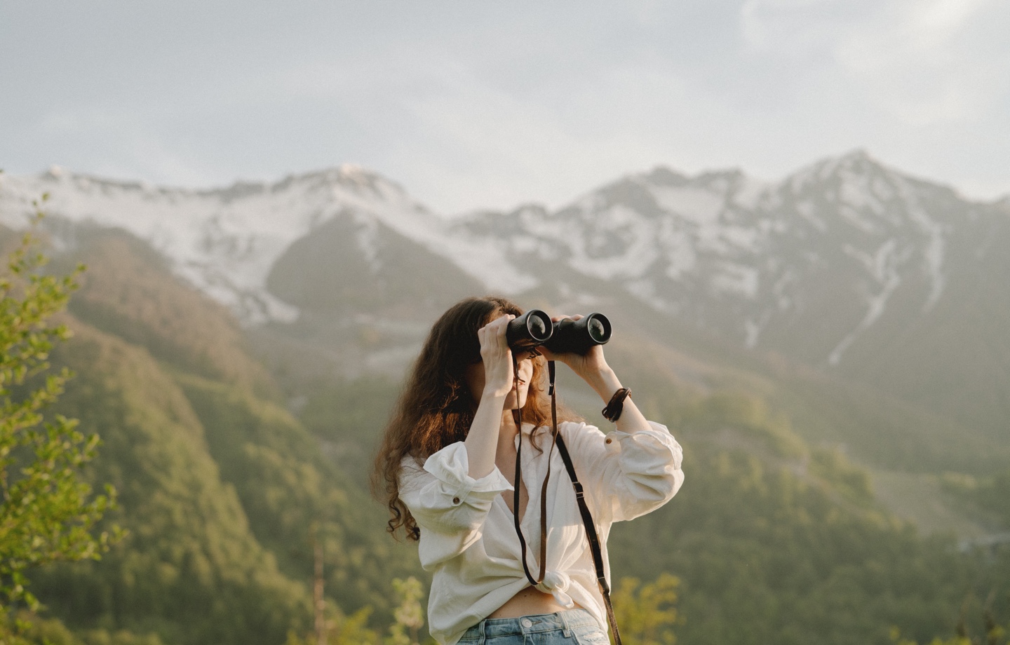 woman looking through binoculars
