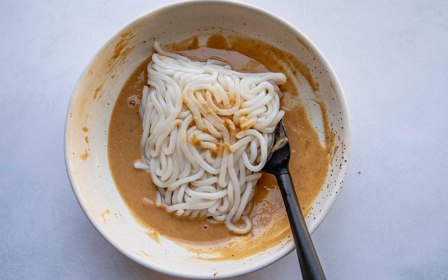 mixing noodles in peanut butter