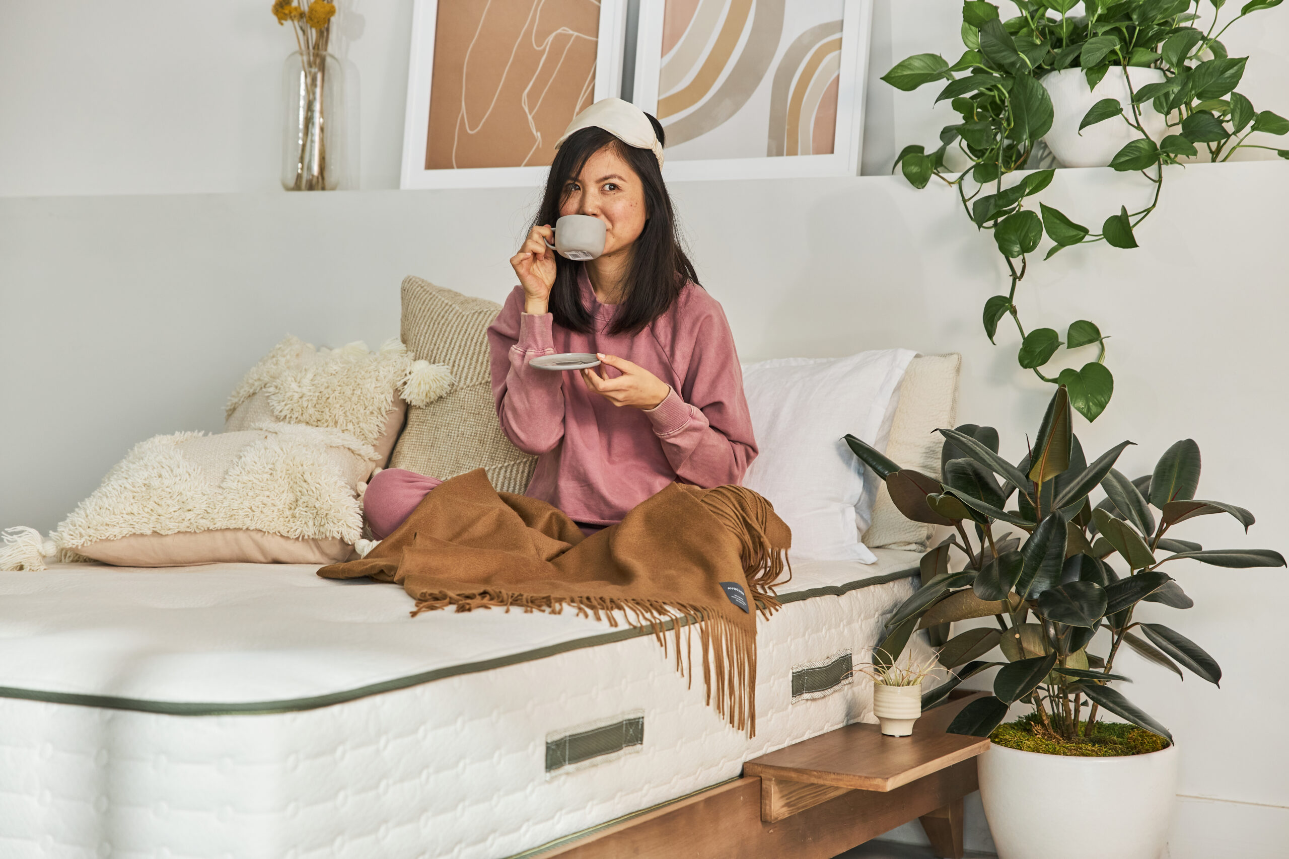 woman drinking coffee in bed