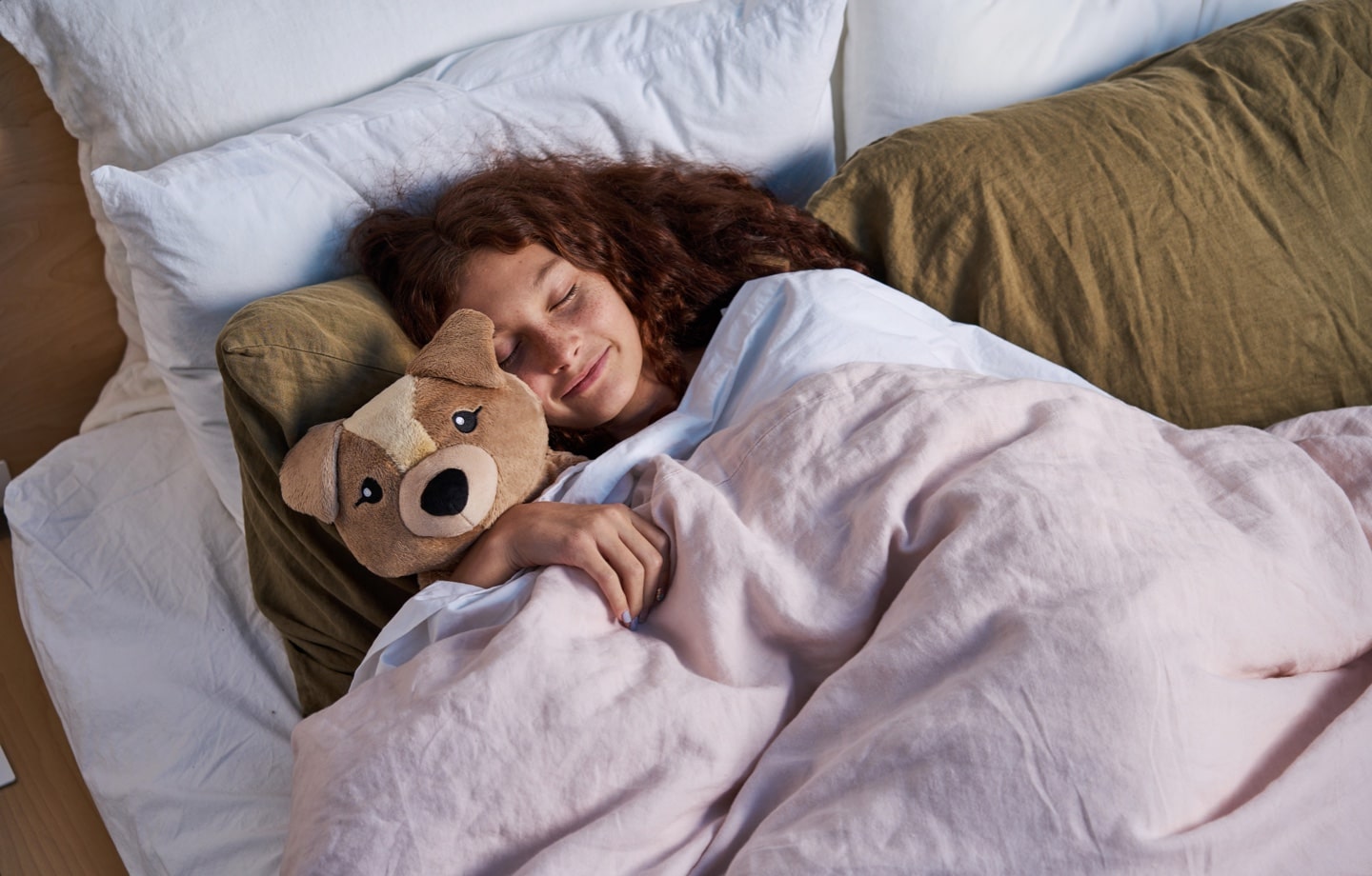 girl cuddling hugimals weighted stuffed animals