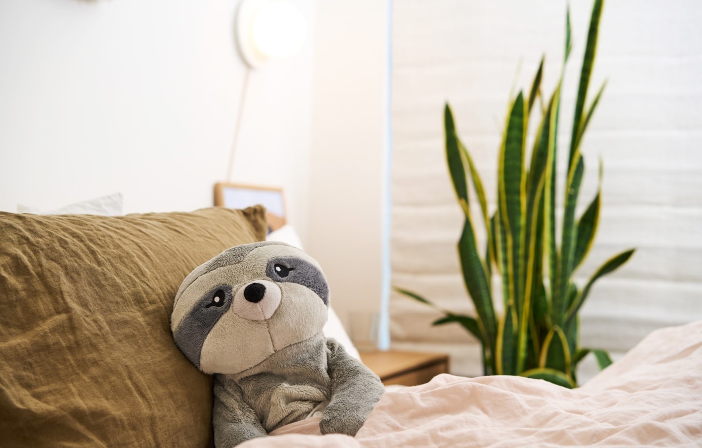 hugimal weighted stuffed animals sitting on a bed