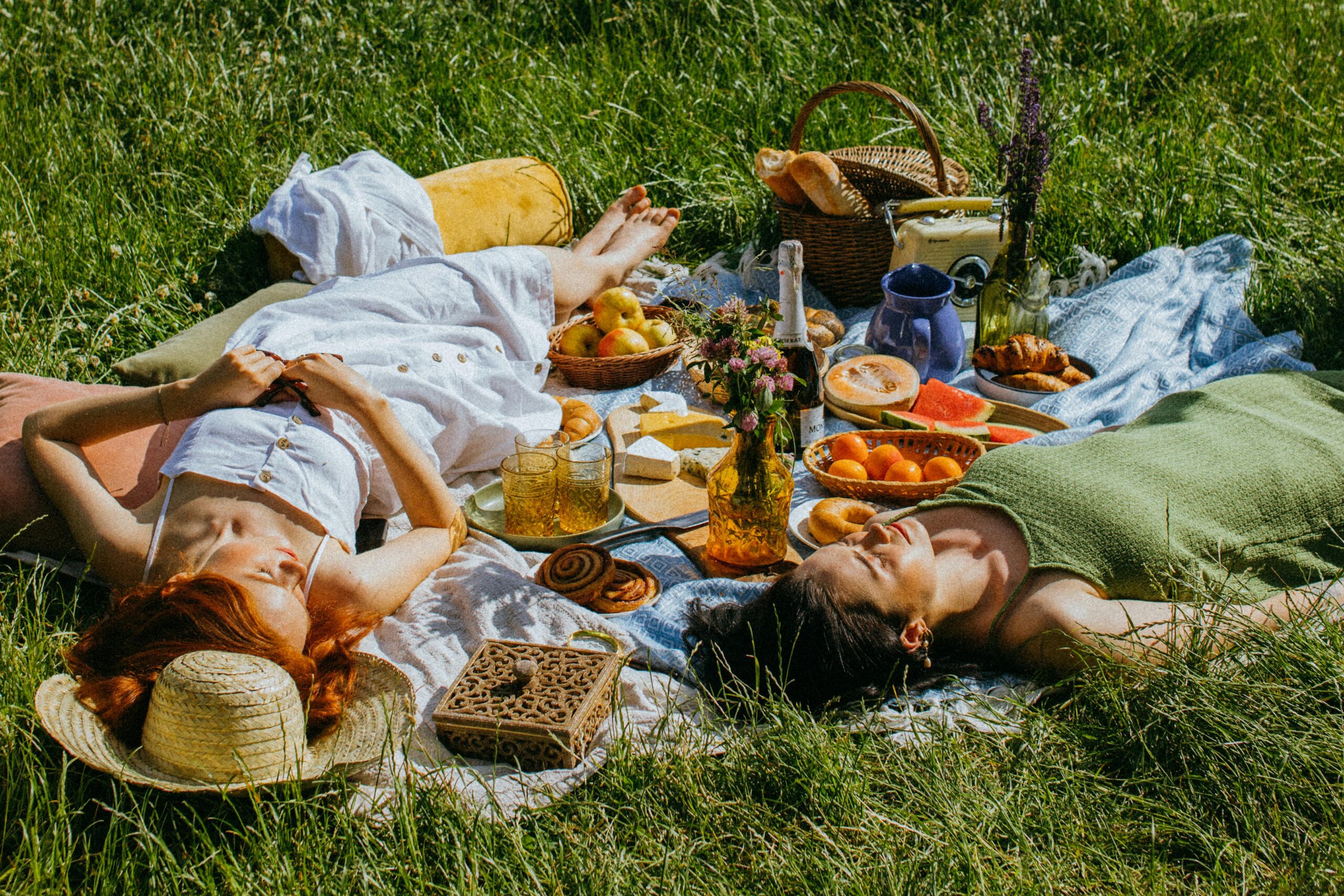 Women sleeping at a picnic with food