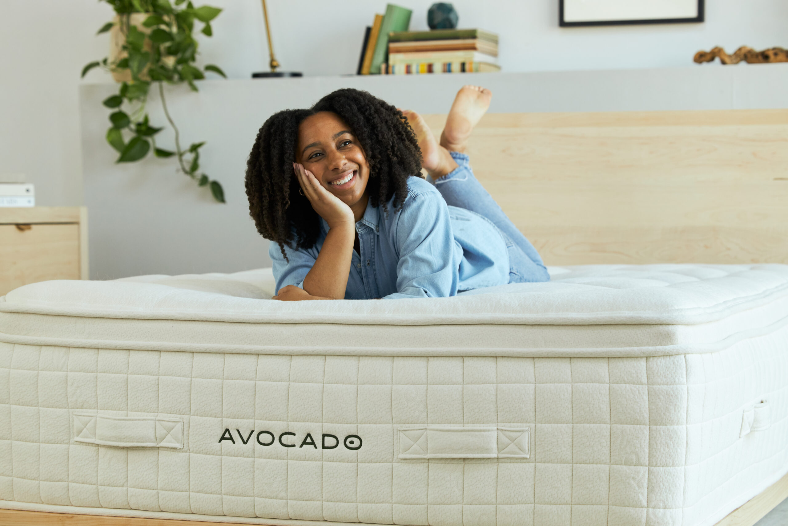 Woman laying on malibu bed frame with luxury mattress