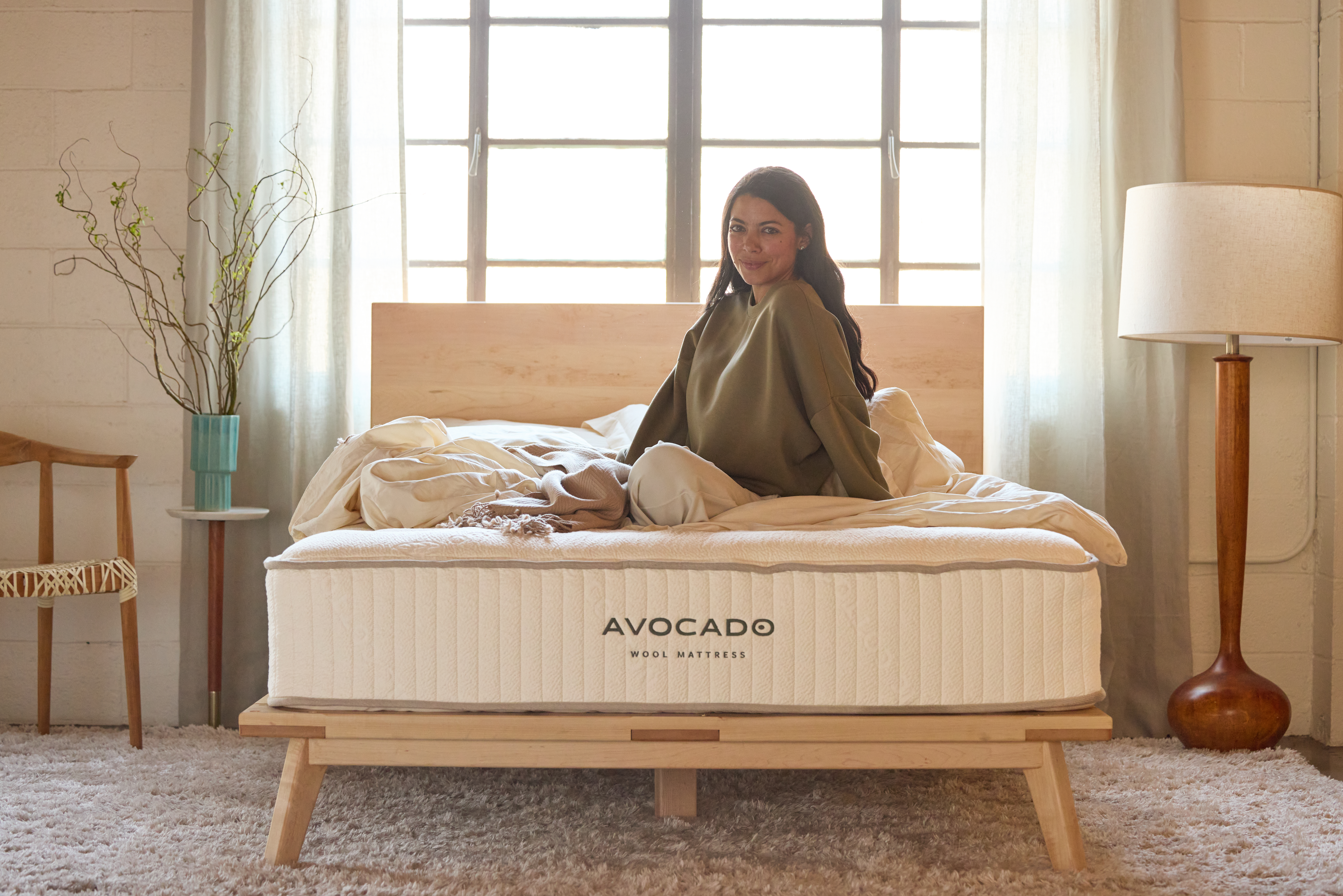 Woman sitting on top of Wool Mattress