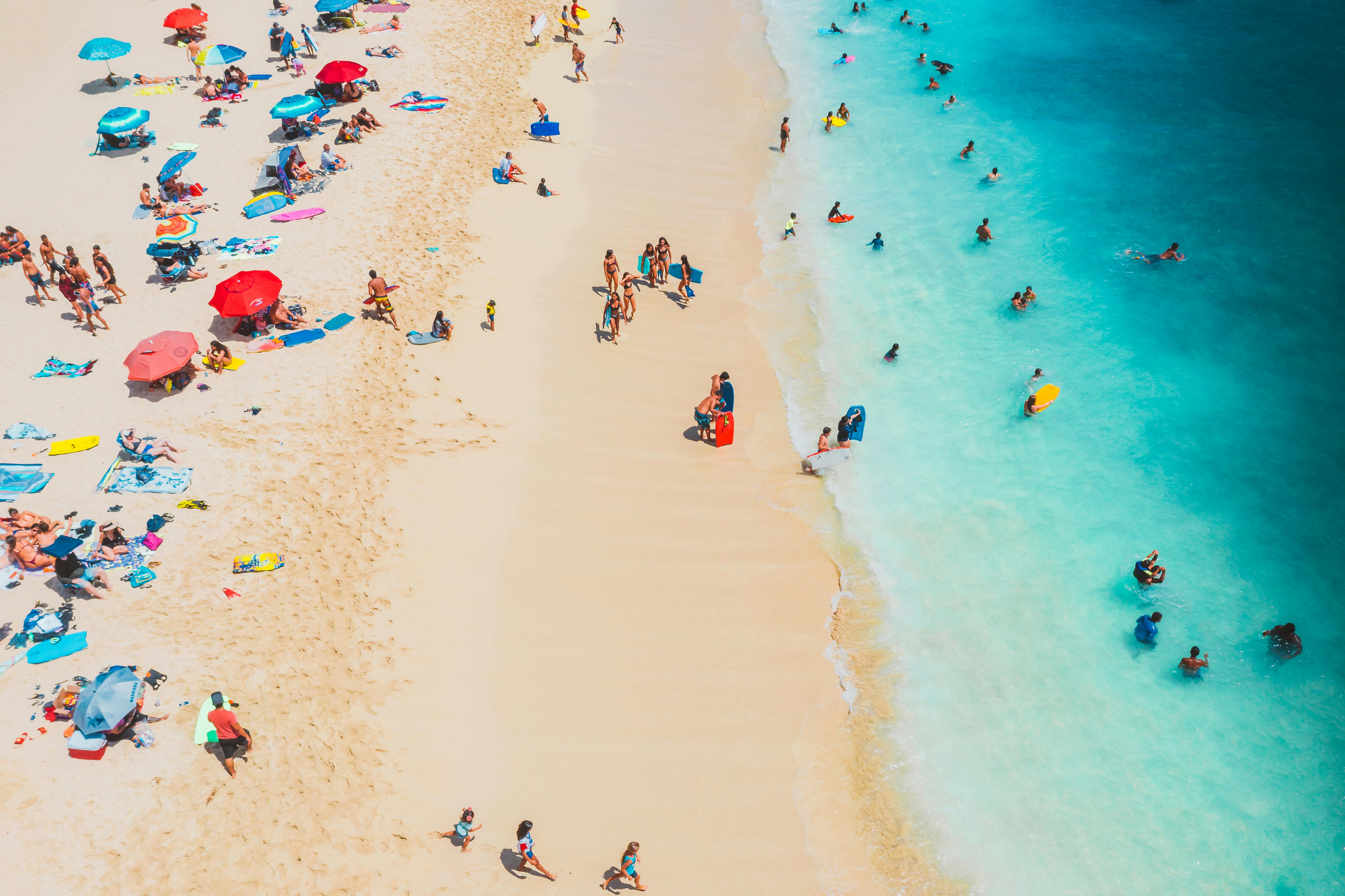 People at the Beach enjoying the sun and water