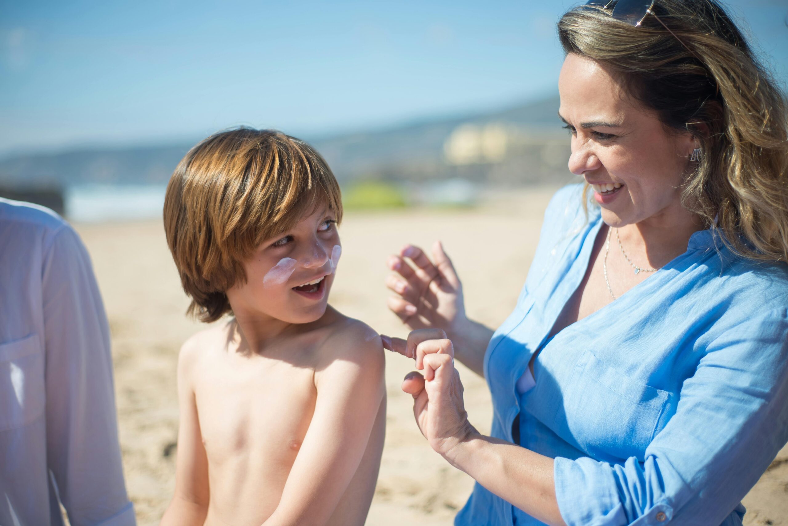Woman putting sunscreen on child