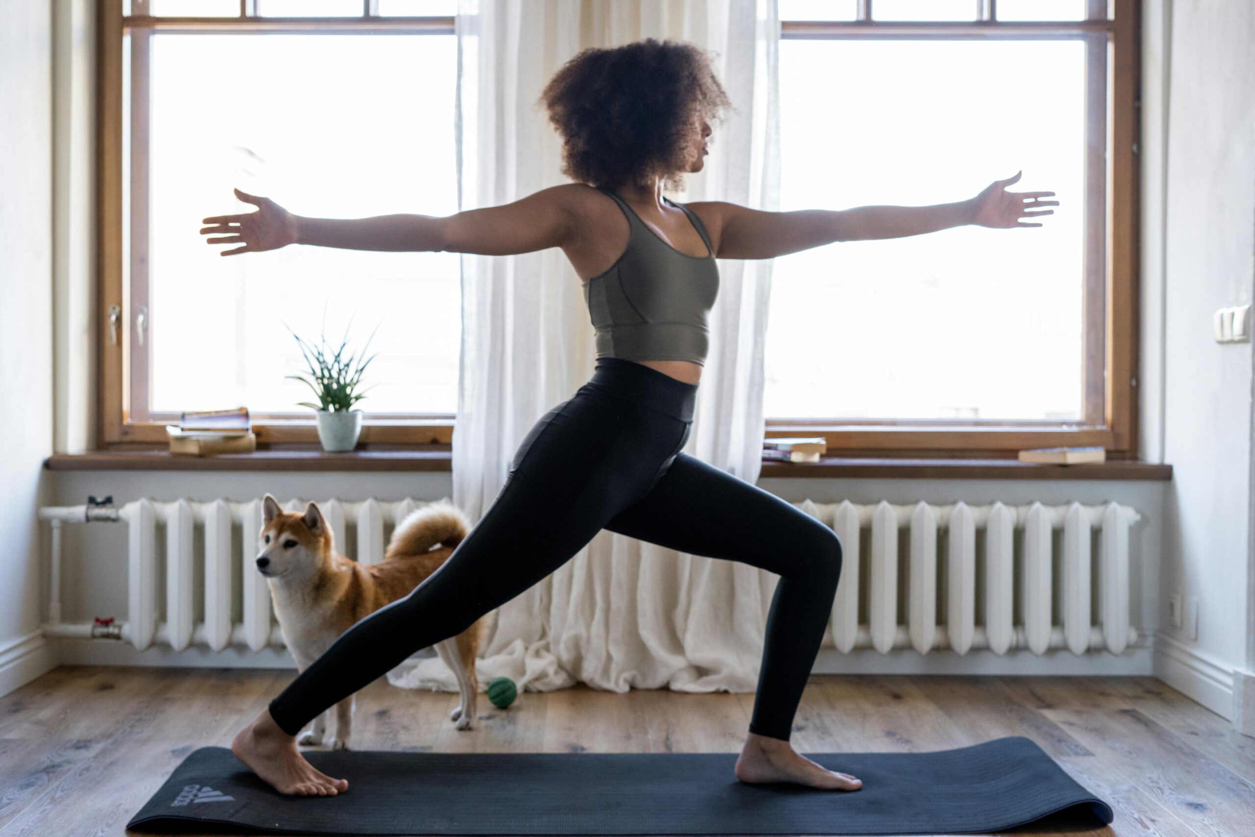 Woman and her dog doing Yoga