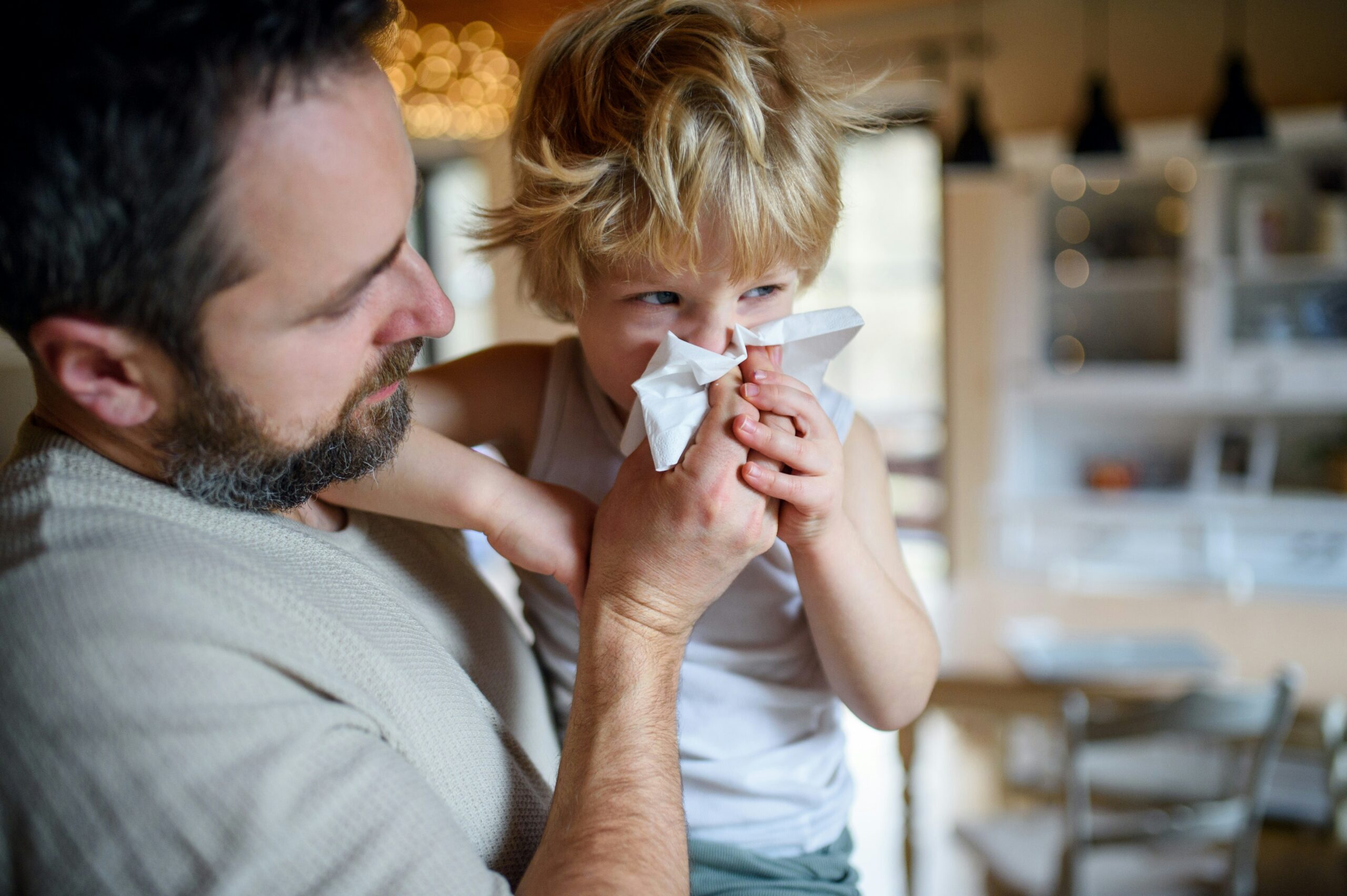 Dad helping his son during cold and flu season