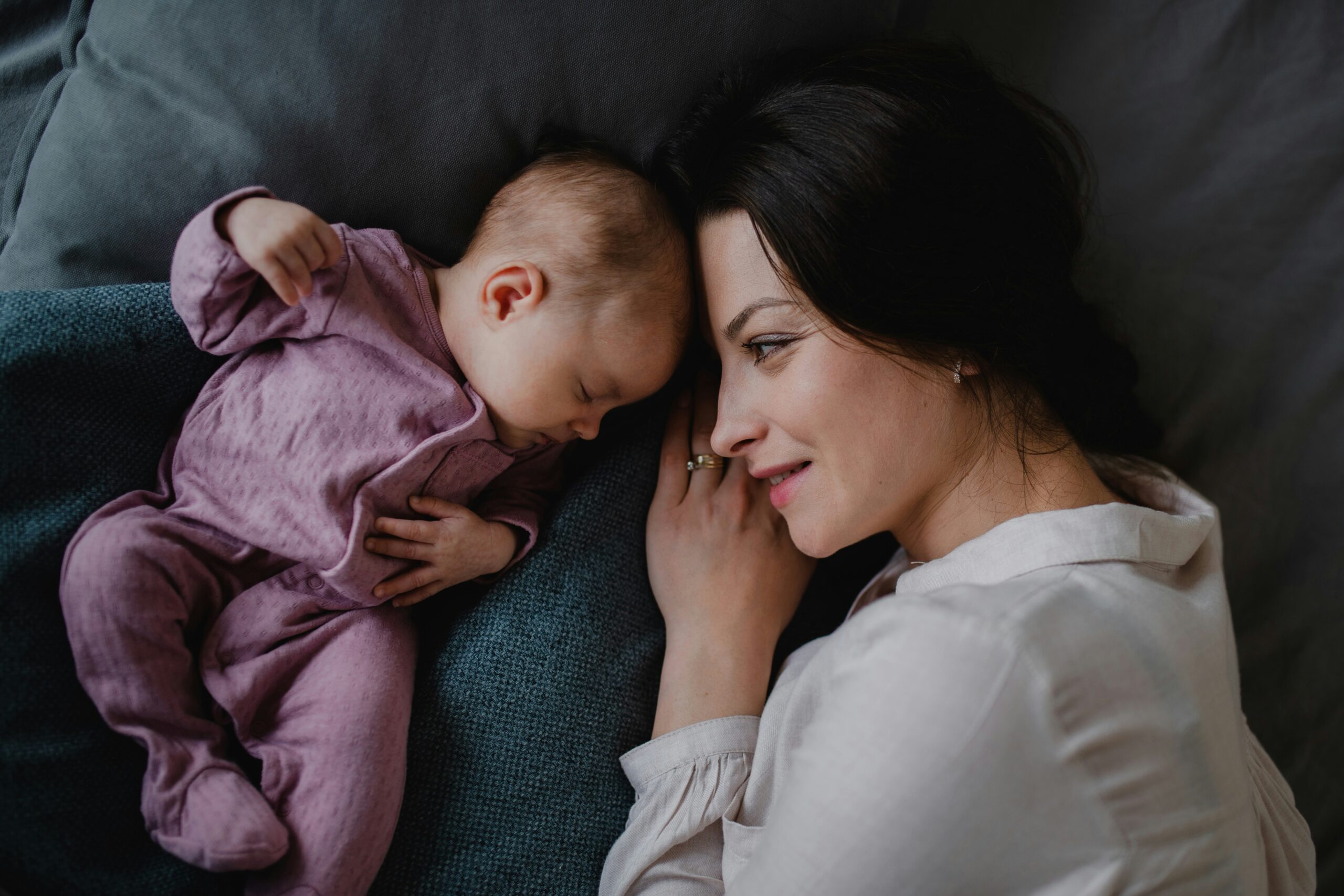 Mother looking at baby sleeping