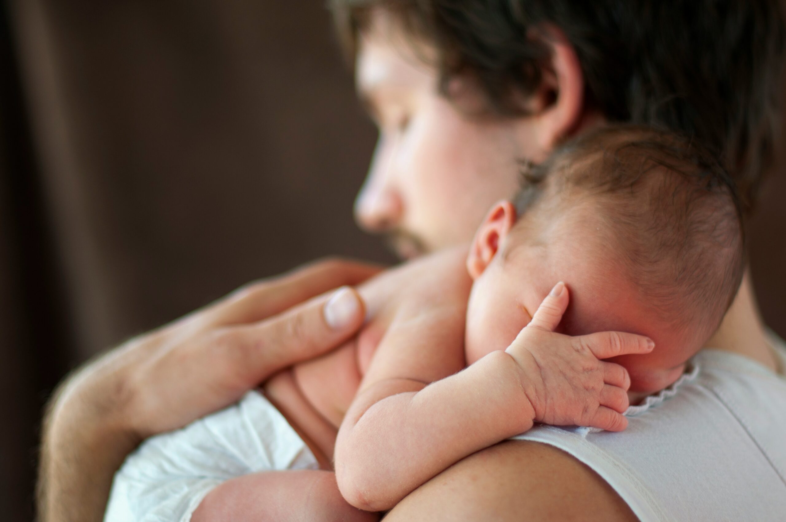 Dad holding newborn baby
