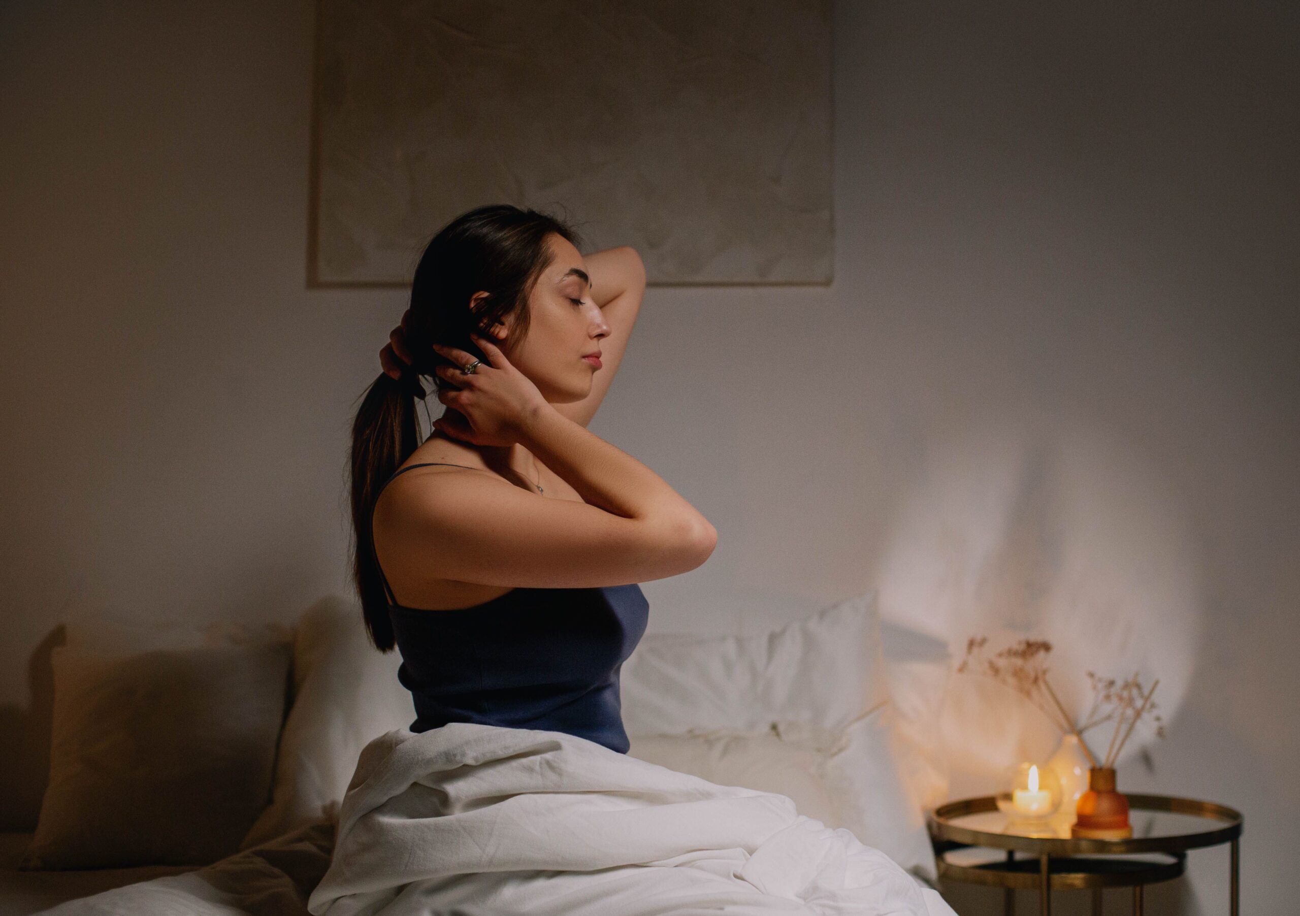 lady sitting on bed with sheets