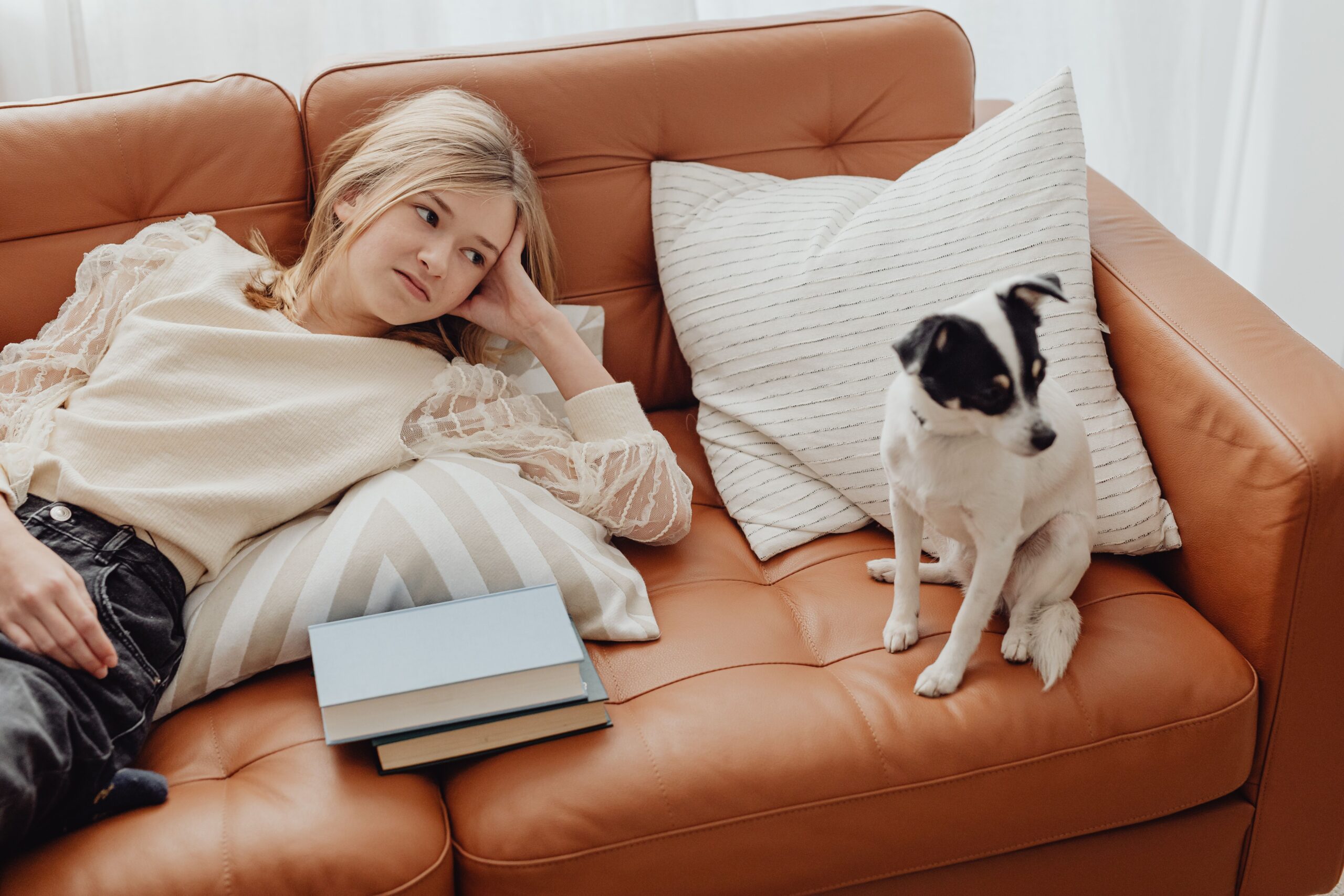 girl and dog on brown leather couch