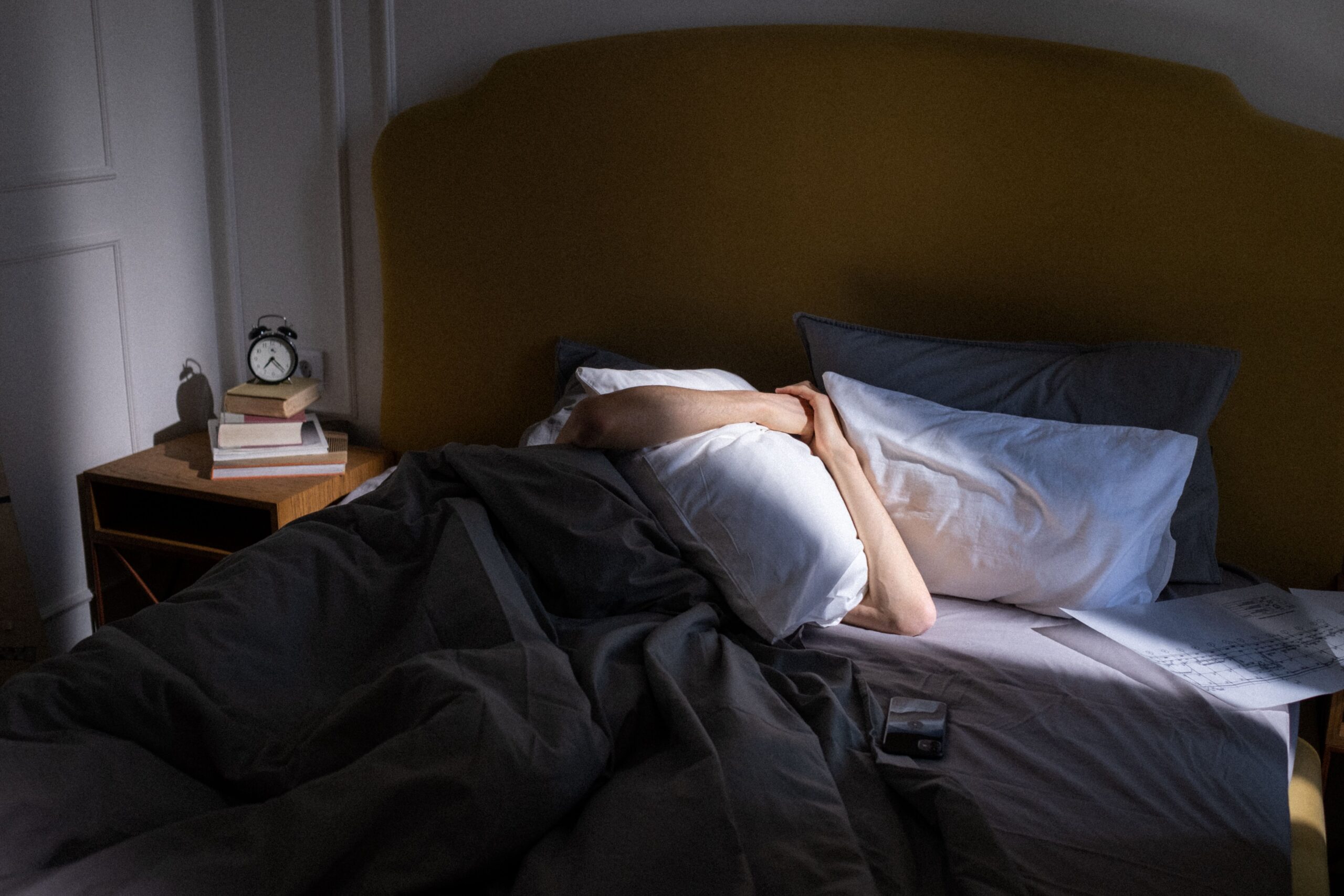 man holding pillow over his face